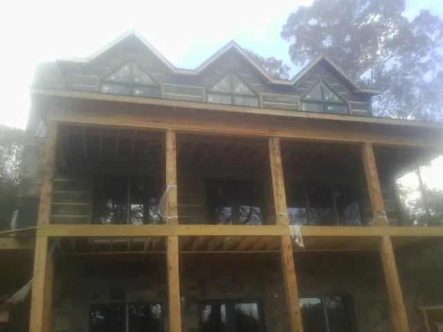 Dormers and porch framing on a large log home under construction in Fruitland